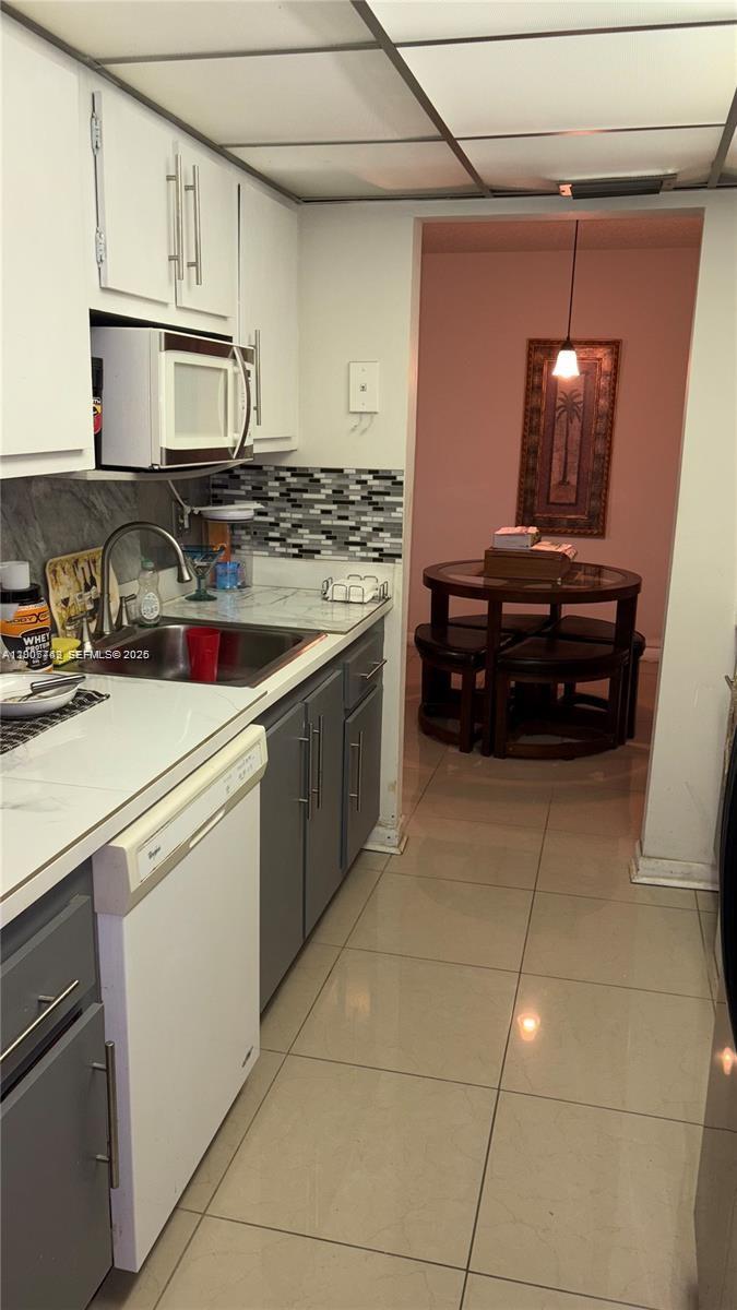 3120 North Pine Island Road, Unit 307 Sunrise, FL 33351 - Photo 2 of 16 a kitchen with a stove and a refrigerator