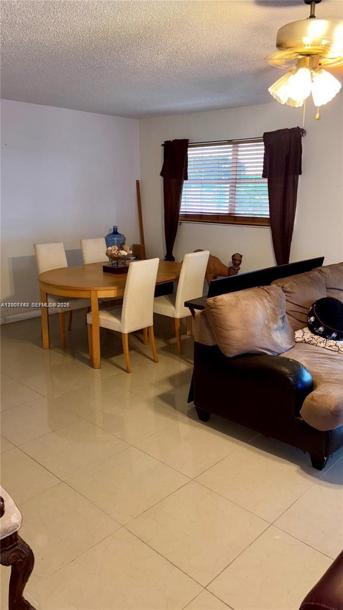 3120 North Pine Island Road, Unit 307 Sunrise, FL 33351 - Photo 3 of 16 a living room with furniture and a window