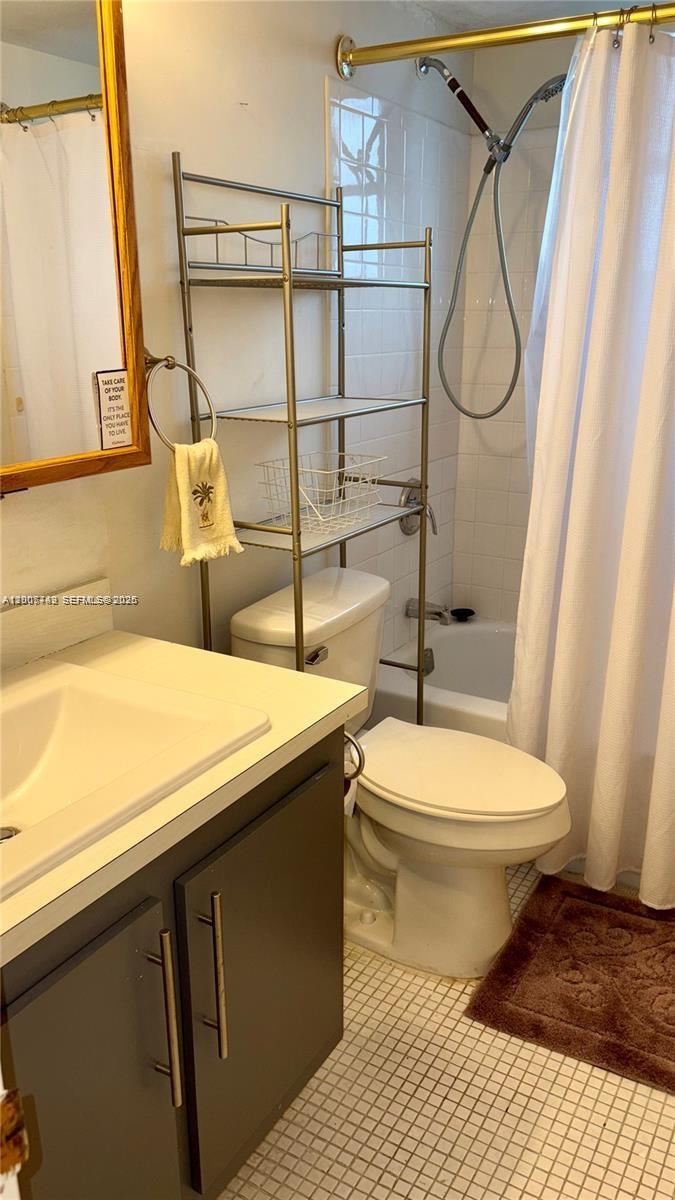 3120 North Pine Island Road, Unit 307 Sunrise, FL 33351 - Photo 8 of 16 a bathroom with a granite countertop sink toilet and shower