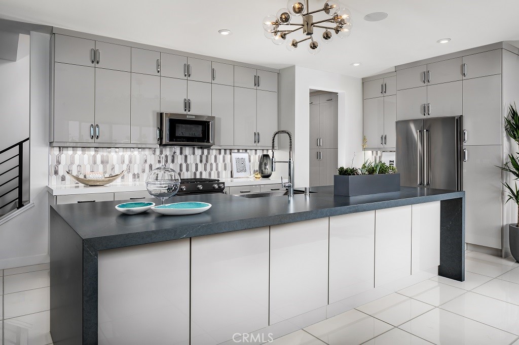 438 Huddle Spgs Way Palm Springs, CA 92264 - Photo 4 of 11 a kitchen with stainless steel appliances a sink and a refrigerator