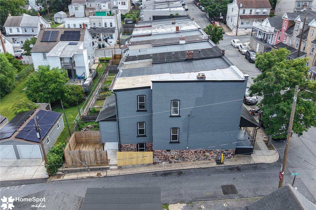 619 Sioux Street Bethlehem, PA 18015 - Photo 55 of 61 An aerial perspective reveals a contemporary residence amidst a bustling neighborhood, featuring a stone foundation and a private backyard.