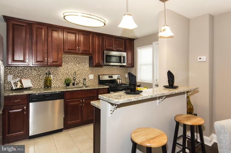 1008 Reverdy Road Baltimore, MD 21212 - Photo 22 of 29 a kitchen with a sink cabinets and window