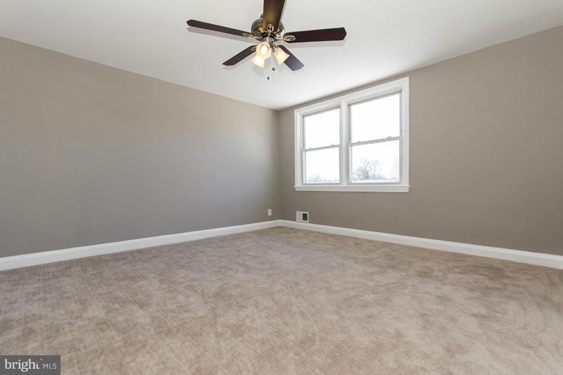 1008 Reverdy Road Baltimore, MD 21212 - Photo 8 of 29 an empty room with windows and fan