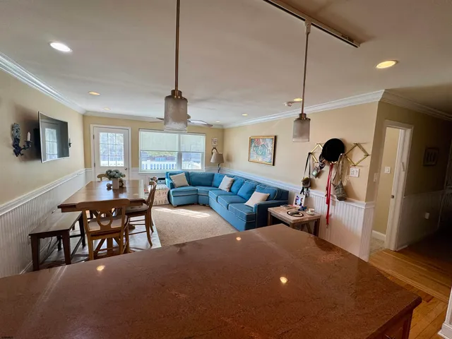 a view of a dining room with furniture and window