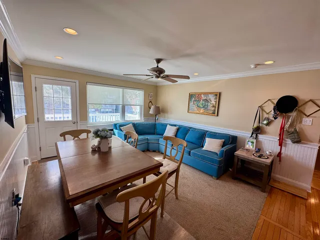 a bedroom with a bed and a flat tv screen on dresser