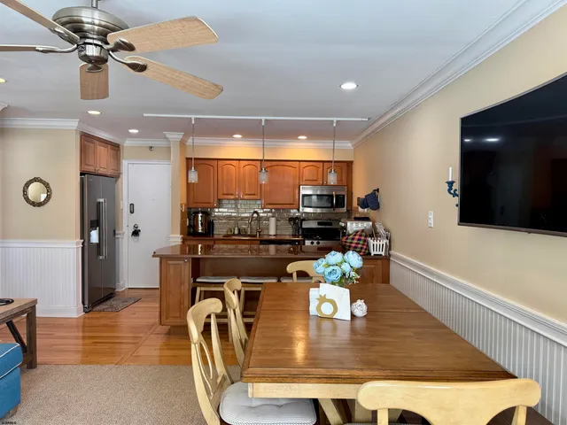a kitchen with stainless steel appliances granite countertop a refrigerator and a sink