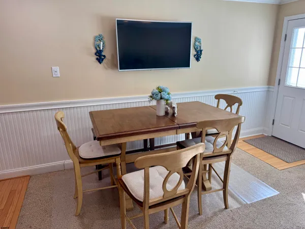 a view of a dining room with furniture and window