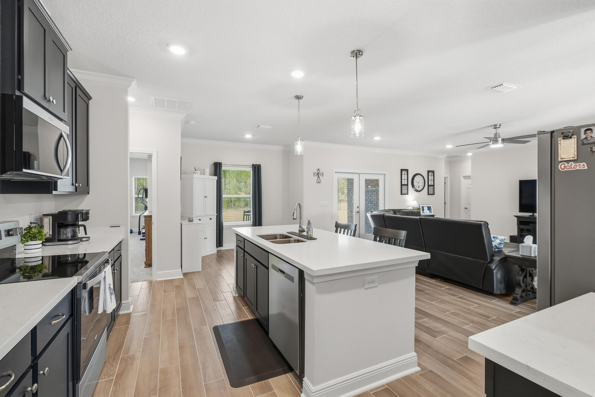 158 Bentgrass Road South Freeport, FL 32439 - Photo 16 of 66 a kitchen with stainless steel appliances kitchen island granite countertop a sink stove and refrigerator