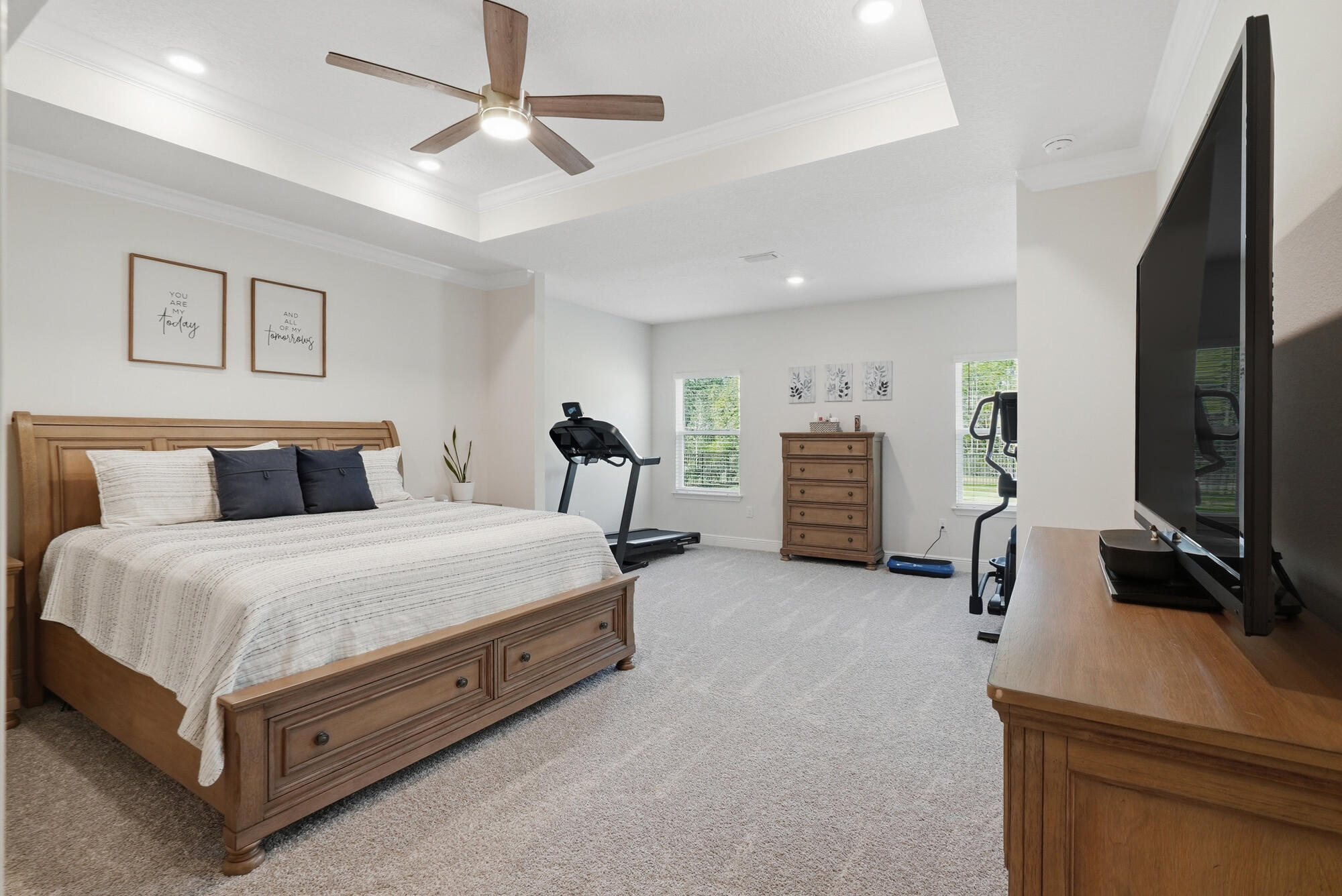 158 Bentgrass Road South Freeport, FL 32439 - Photo 19 of 66 a spacious bedroom with a bed and a flat tv screen on dresser