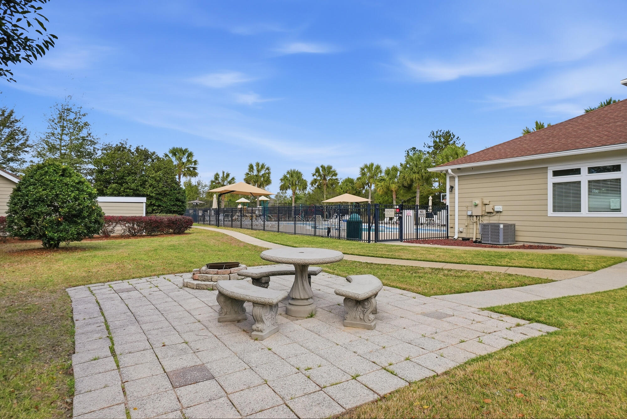 158 Bentgrass Road South Freeport, FL 32439 - Photo 46 of 66 a view of a white house with a swimming pool and a yard