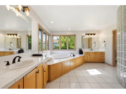 a large bathroom with a large tub sink and vanity