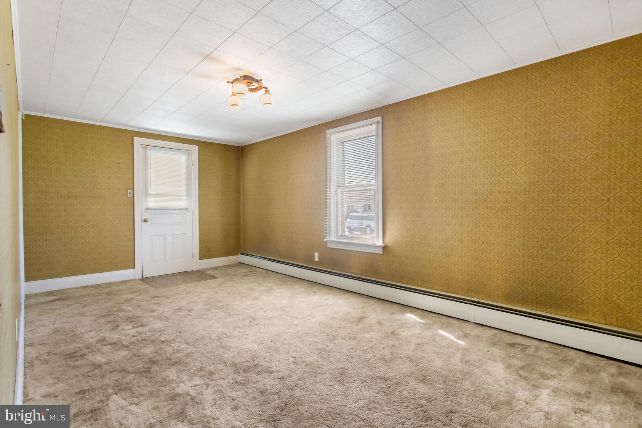 235 Ridge Avenue McSherrystown, PA 17344 - Photo 8 of 26 an empty room with a empty space and windows