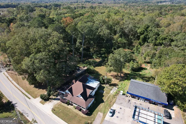 an aerial view of a house with a yard