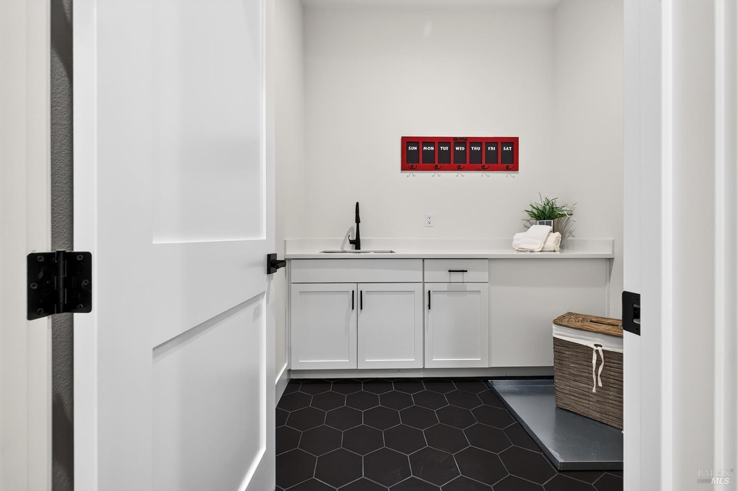 1925 Carlile Place Santa Rosa, CA 95403 - Photo 48 of 70 Next to the two secondary bedrooms is this large laundry room with tile flooring.