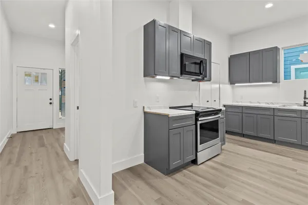 a kitchen with granite countertop a sink and steel appliances
