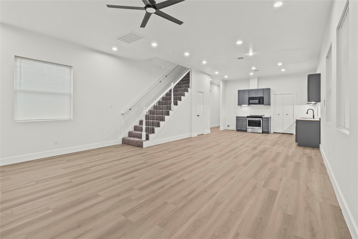 8129 Hoffman Street Houston, TX 77016 - Photo 8 of 18 a view of a kitchen with furniture and a ceiling fan