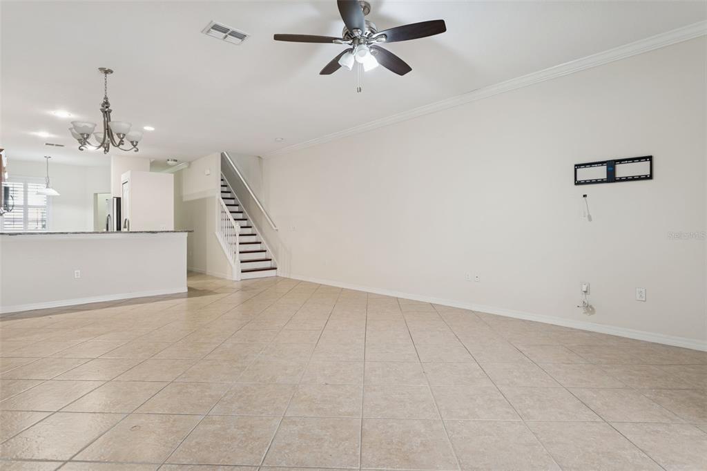 9568 Trumpet Vine Loop Trinity, FL 34655 - Photo 11 of 25 an empty room with chandelier fan and windows