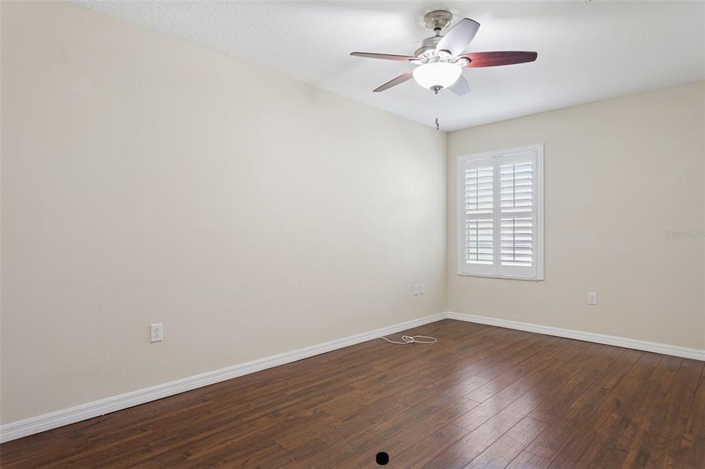 9568 Trumpet Vine Loop Trinity, FL 34655 - Photo 14 of 25 wooden floor in an empty room with a window