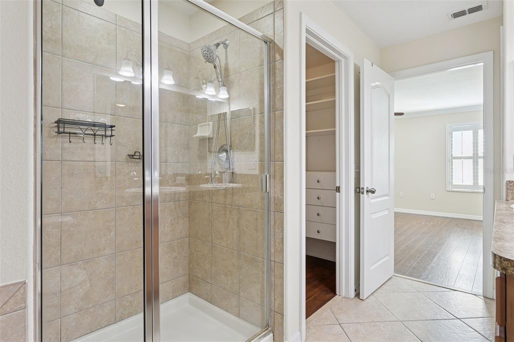 9568 Trumpet Vine Loop Trinity, FL 34655 - Photo 19 of 25 a bathroom with a shower and a glass door