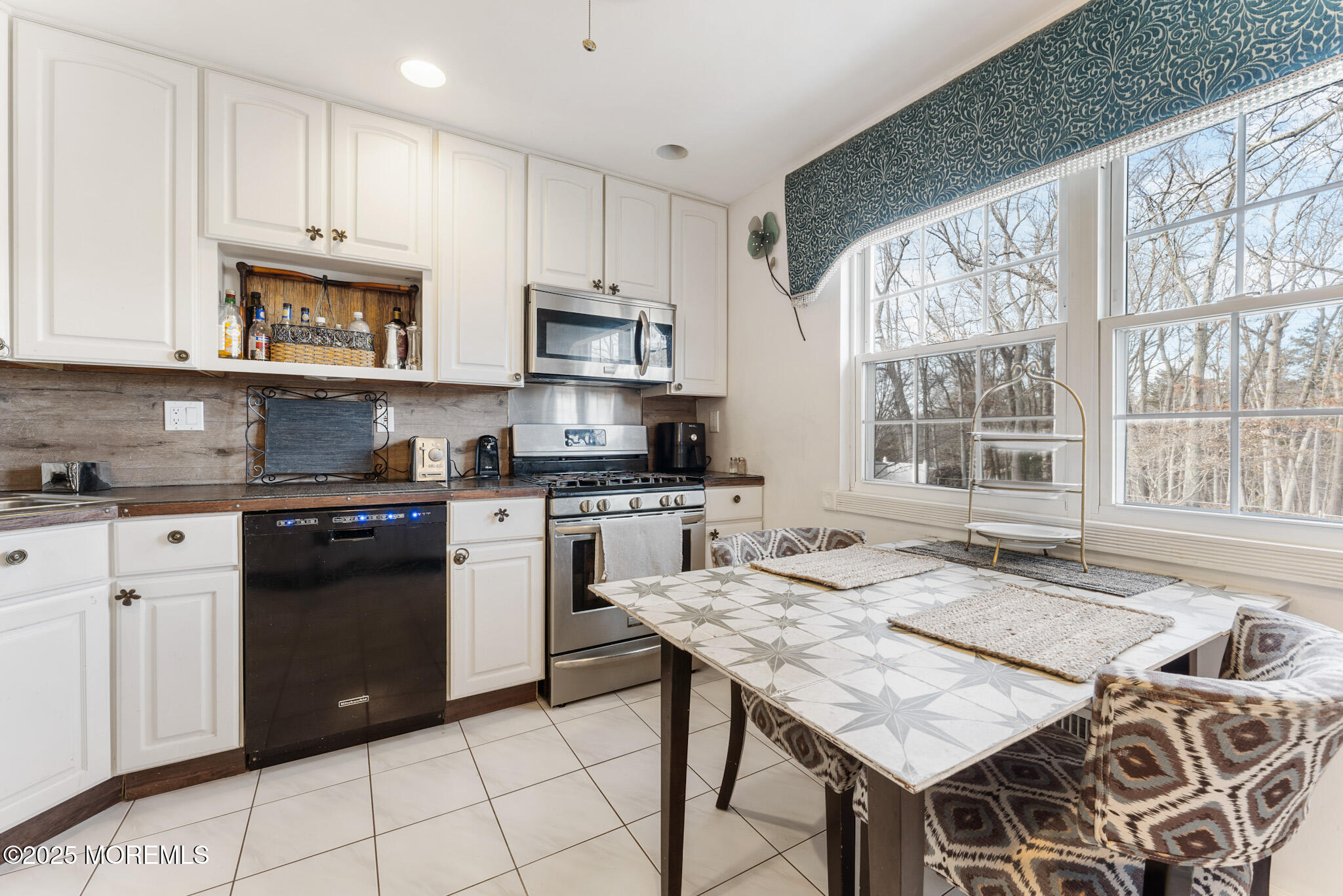 4 Yorkshire Drive Jackson, NJ 08527 - Photo 21 of 58 a kitchen with stainless steel appliances granite countertop a stove a sink a microwave a dining table and chairs