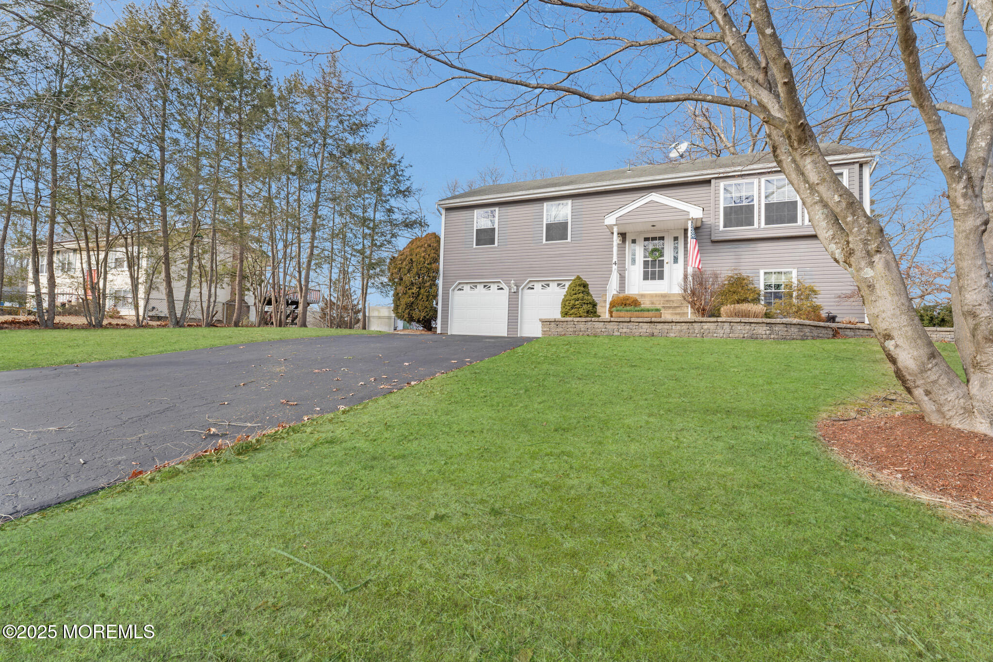 4 Yorkshire Drive Jackson, NJ 08527 - Photo 3 of 58 a front view of a house with a yard and garage