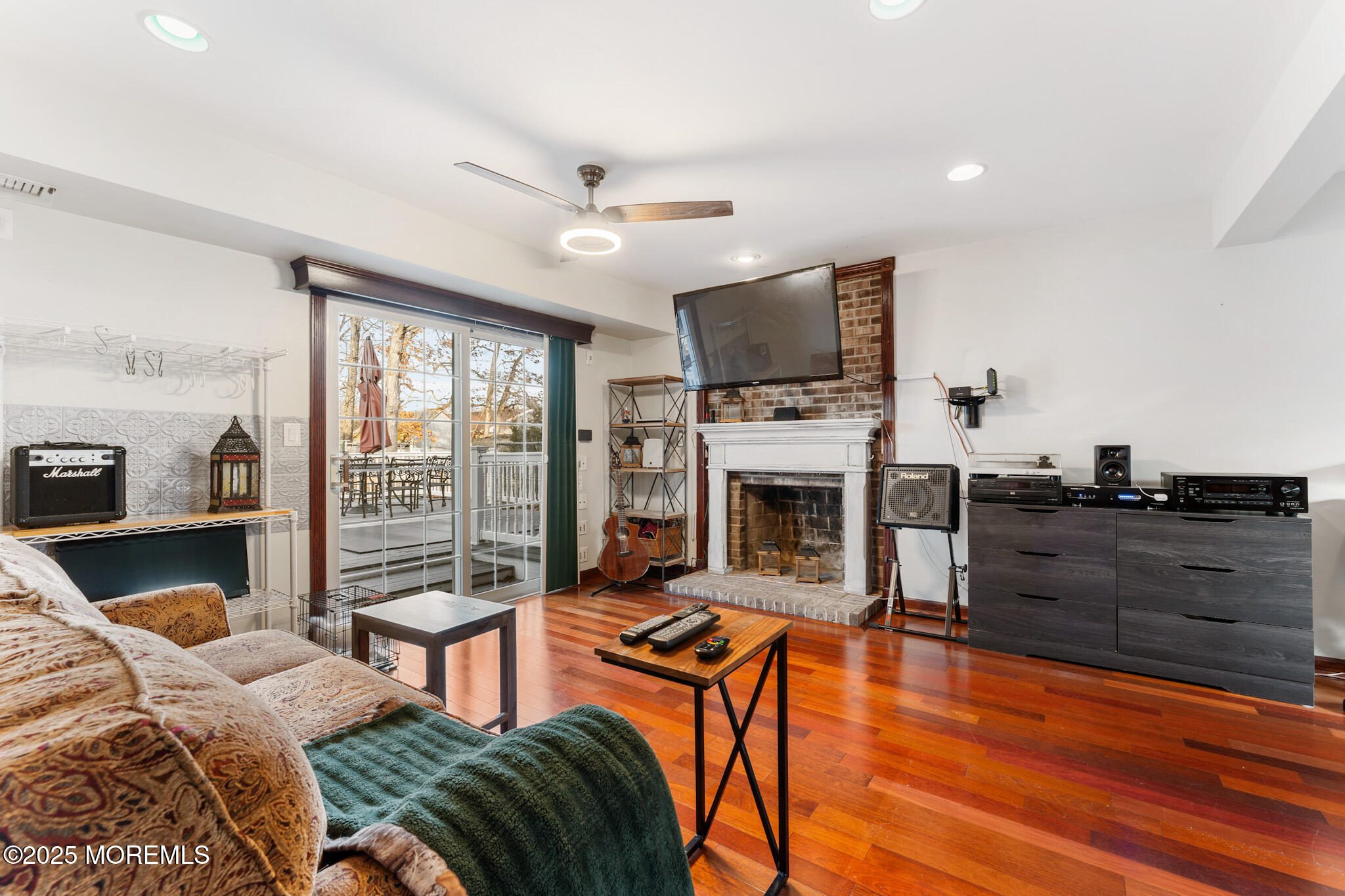 4 Yorkshire Drive Jackson, NJ 08527 - Photo 34 of 58 a living room with furniture a fireplace and a flat screen tv