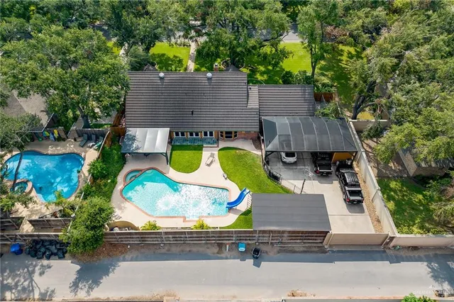 an aerial view of residential house with outdoor space and swimming pool