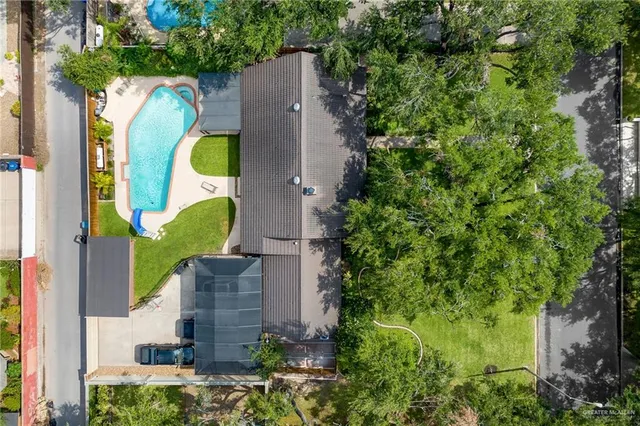 an aerial view of a house with a swimming pool