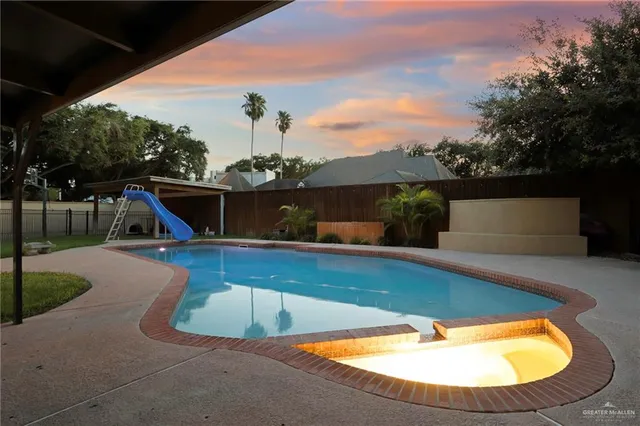 a view of a swimming pool with a patio