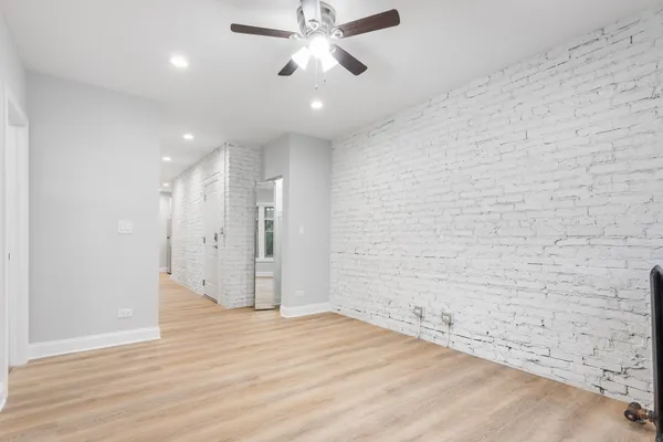 a view of a livingroom with a ceiling fan window and wooden floor
