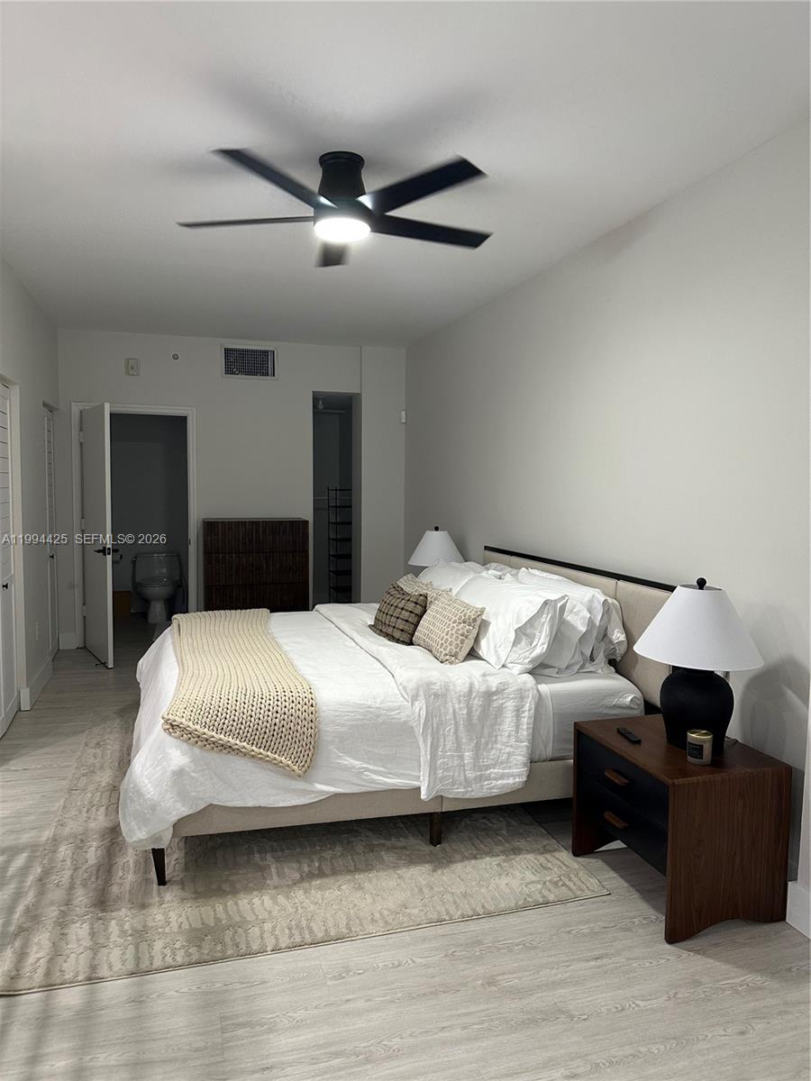 3339 Virginia Street, Unit 127 Miami, FL 33133 - Photo 17 of 25 a spacious bedroom with a bed and a couch