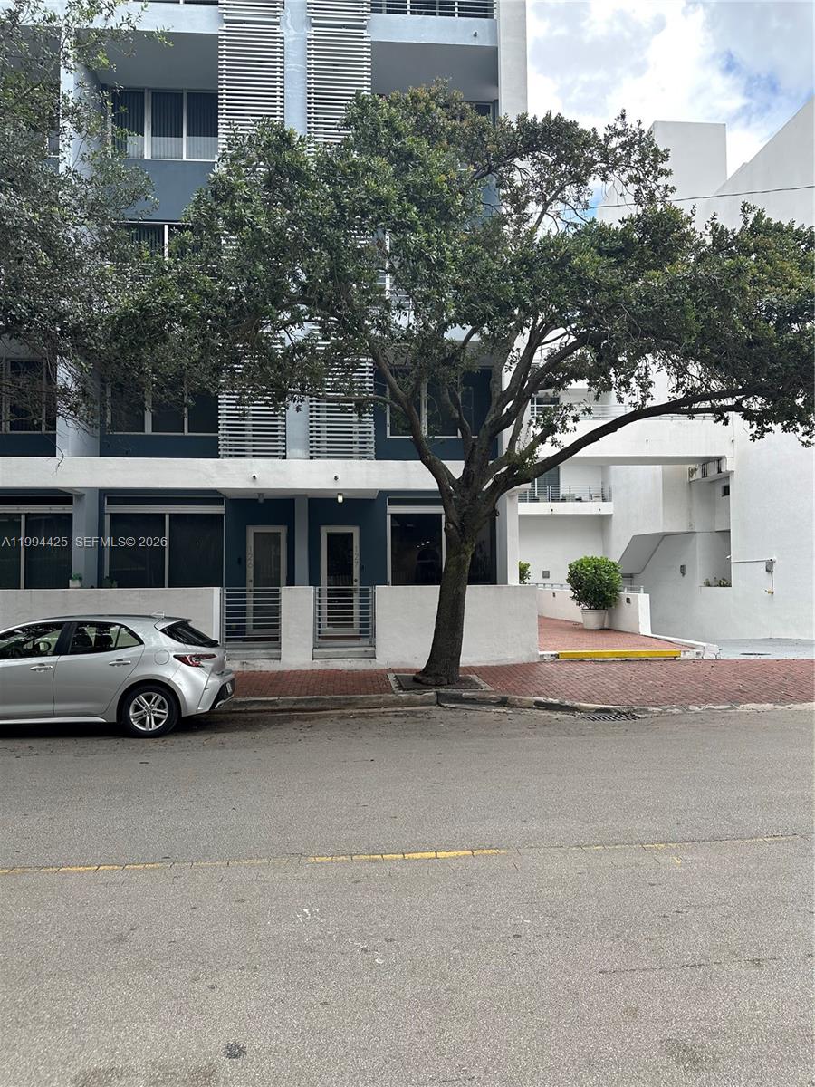 3339 Virginia Street, Unit 127 Miami, FL 33133 - Photo 2 of 25 a front view of a house with a yard