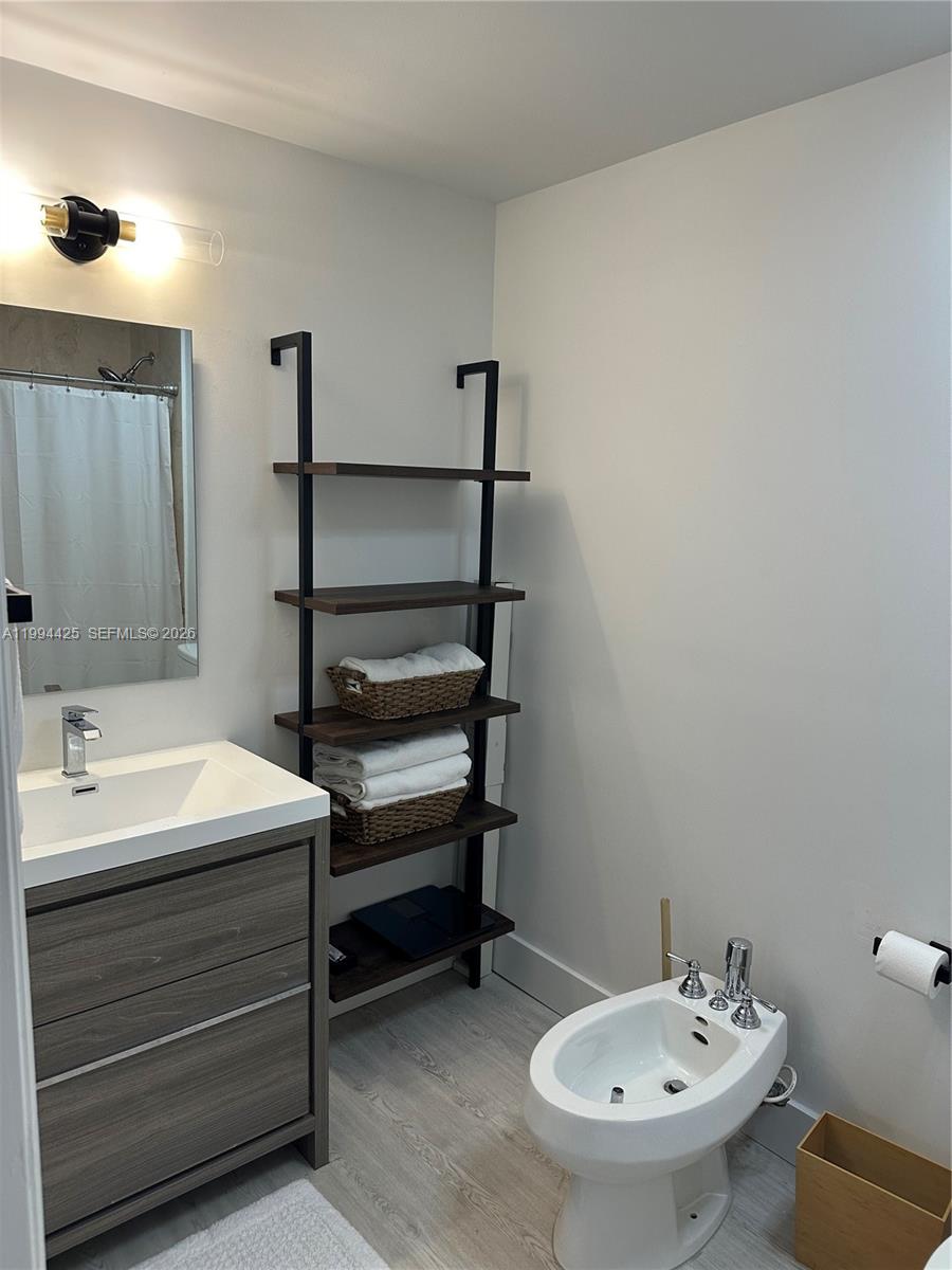 3339 Virginia Street, Unit 127 Miami, FL 33133 - Photo 22 of 25 a bathroom with a sink and a mirror