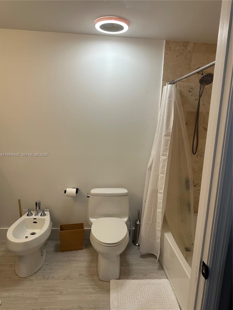 3339 Virginia Street, Unit 127 Miami, FL 33133 - Photo 23 of 25 a white toilet sitting next to a bathroom sink