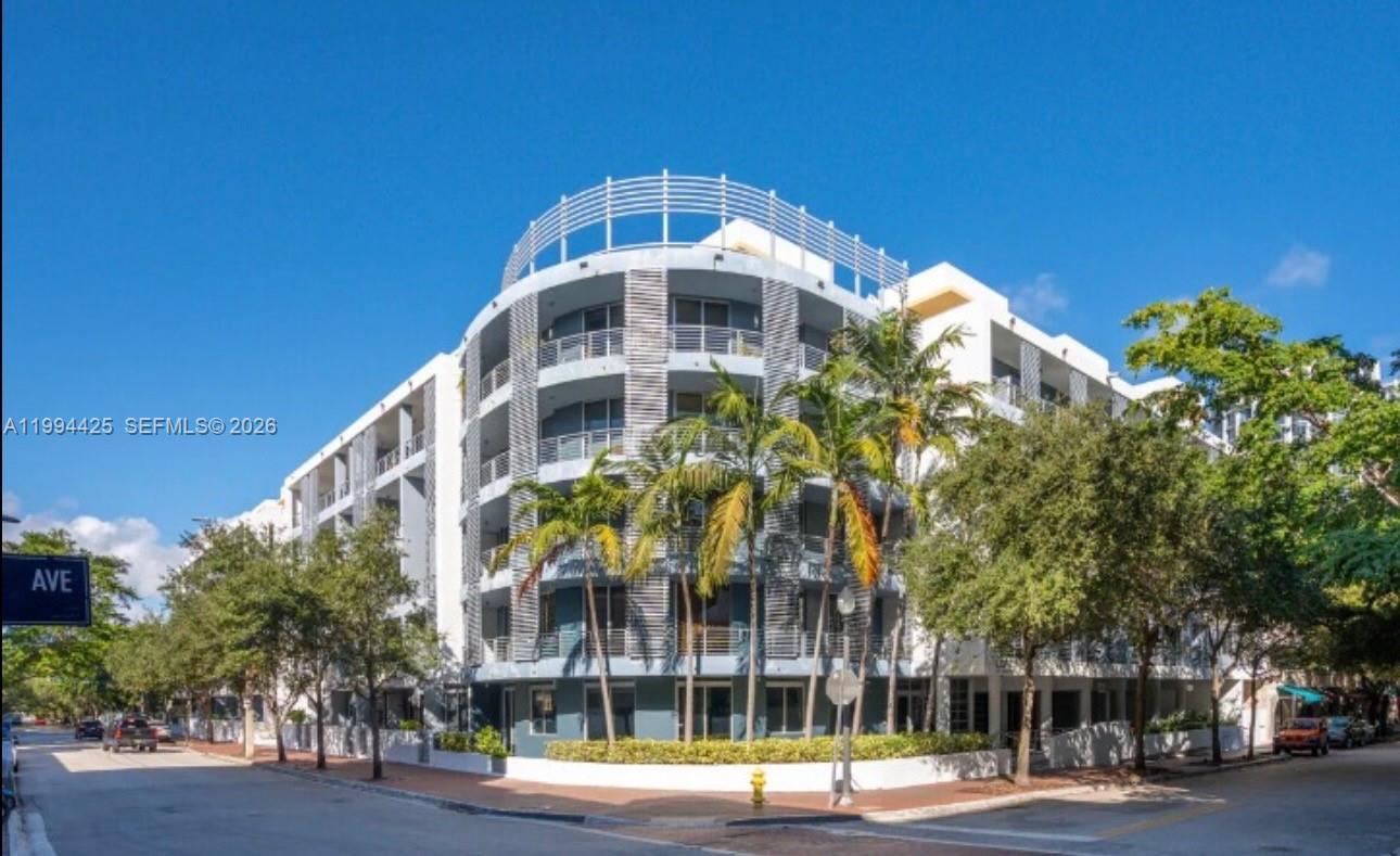 3339 Virginia Street, Unit 127 Miami, FL 33133 - Photo 24 of 25 a front view of a building with a yard