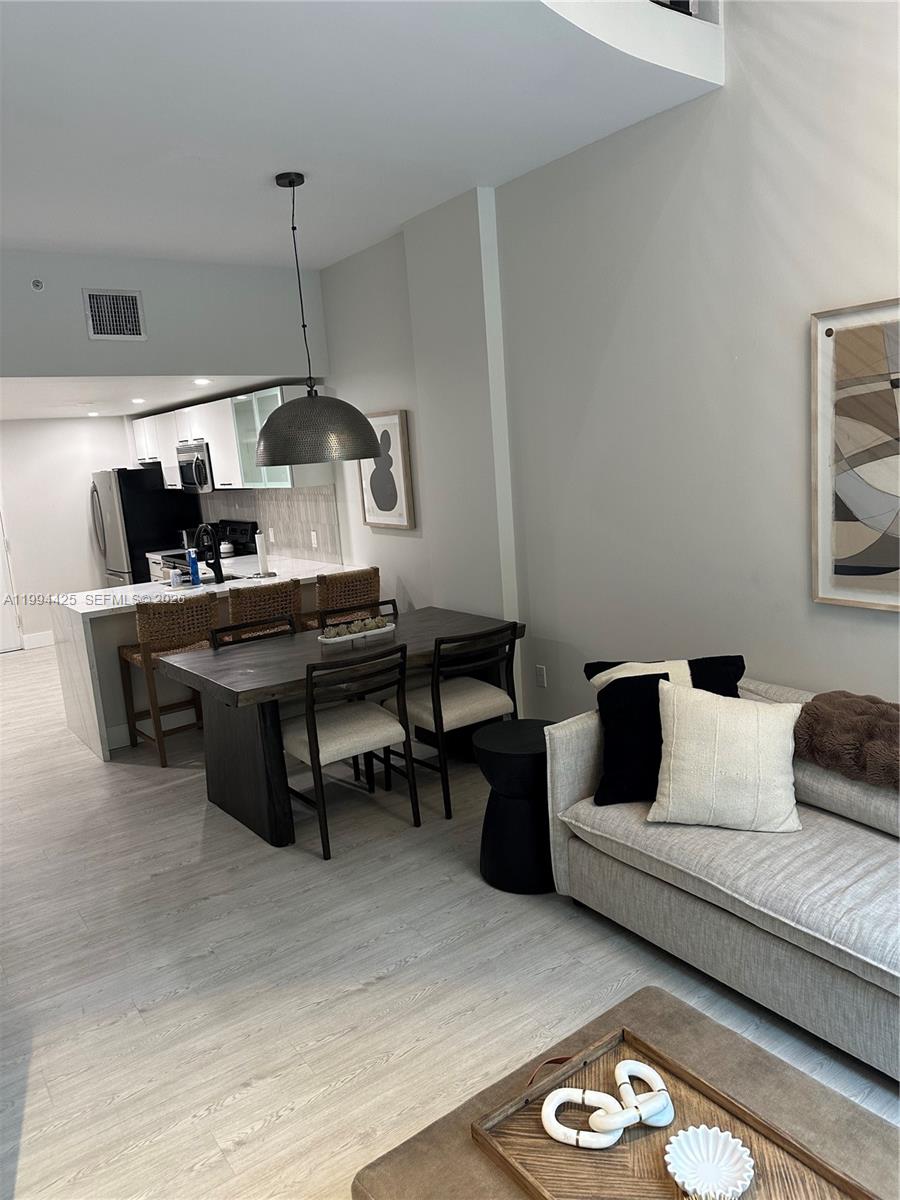 3339 Virginia Street, Unit 127 Miami, FL 33133 - Photo 3 of 25 a living room with furniture
