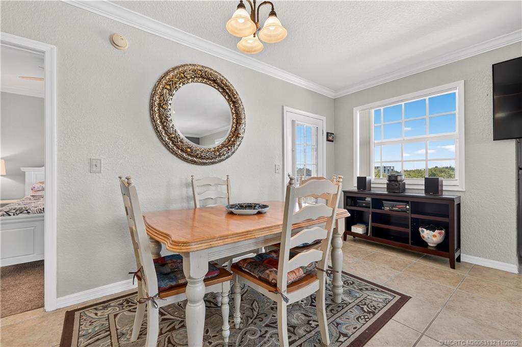 160 Southwest Peacock Boulevard, Unit 31203 Port St. Lucie, FL 34986 - Photo 12 of 43 a dining room with furniture and a mirror