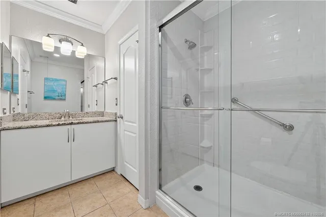 a bathroom with a granite countertop sink mirror and a shower