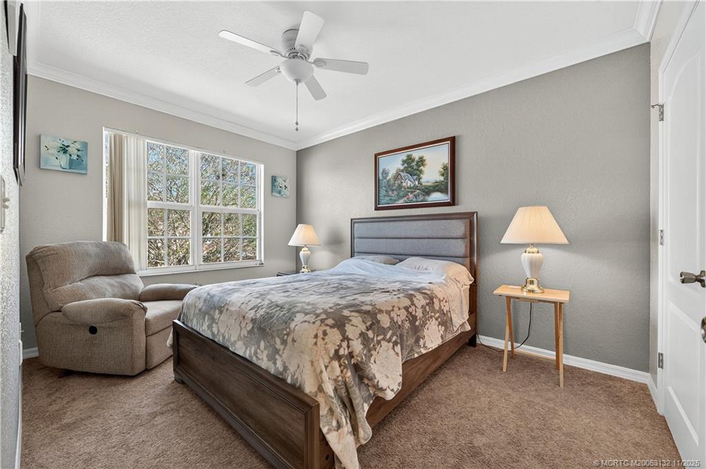 160 Southwest Peacock Boulevard, Unit 31203 Port St. Lucie, FL 34986 - Photo 23 of 43 a bedroom with a bed and a window