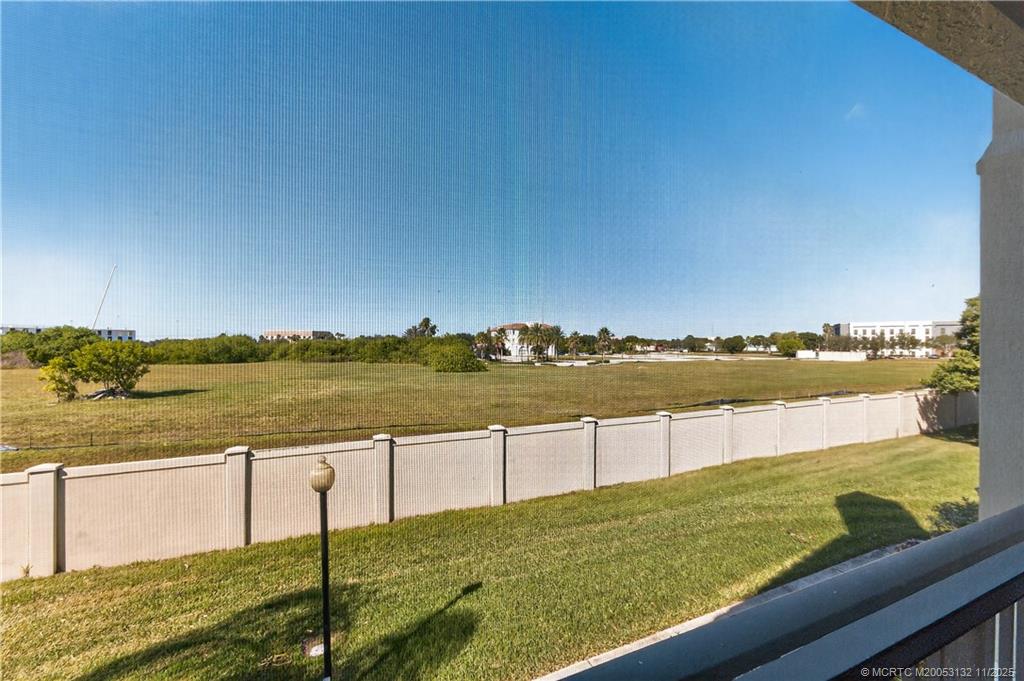 160 Southwest Peacock Boulevard, Unit 31203 Port St. Lucie, FL 34986 - Photo 28 of 43 a view of a lake with houses in the back