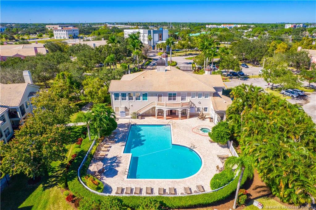 160 Southwest Peacock Boulevard, Unit 31203 Port St. Lucie, FL 34986 - Photo 30 of 43 a view of a swimming pool with a yard