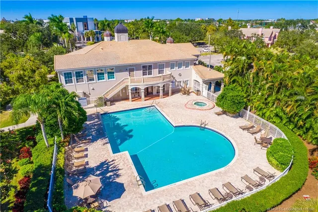 an aerial view of a house with a garden and lake view