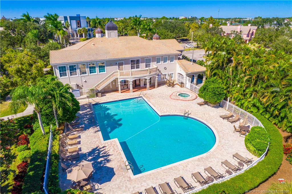 160 Southwest Peacock Boulevard, Unit 31203 Port St. Lucie, FL 34986 - Photo 31 of 43 an aerial view of a house with a garden and lake view