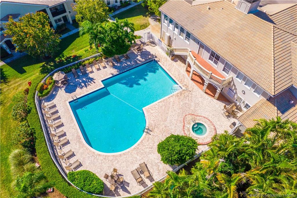 160 Southwest Peacock Boulevard, Unit 31203 Port St. Lucie, FL 34986 - Photo 32 of 43 an aerial view of a house with a swimming pool and garden