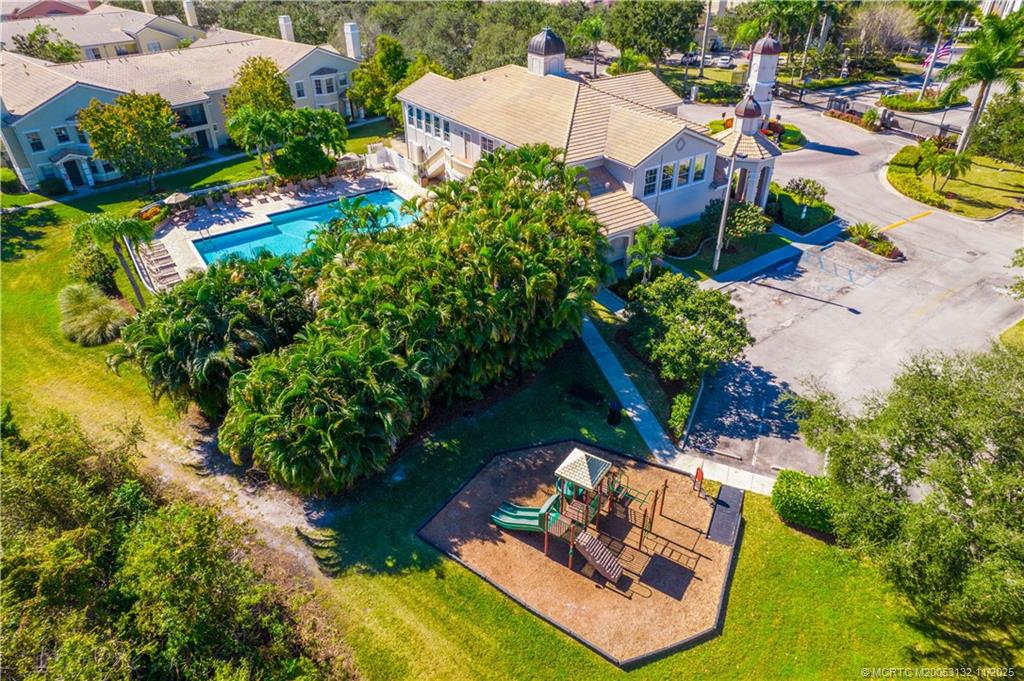 160 Southwest Peacock Boulevard, Unit 31203 Port St. Lucie, FL 34986 - Photo 33 of 43 an aerial view of a house with a garden and swimming pool