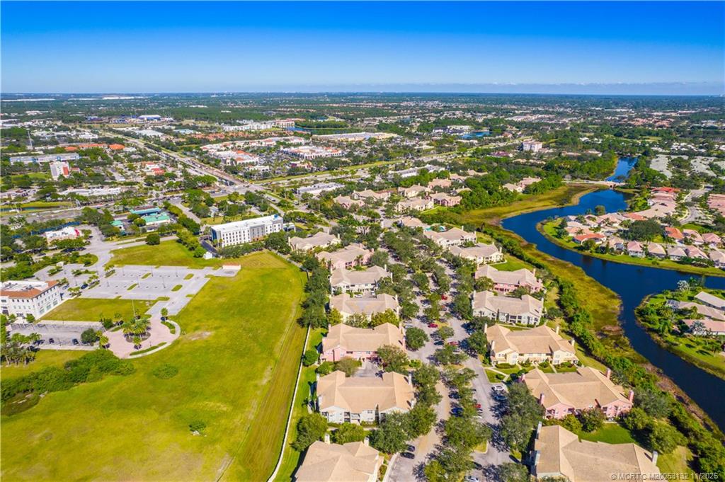 160 Southwest Peacock Boulevard, Unit 31203 Port St. Lucie, FL 34986 - Photo 39 of 43 an aerial view of residential building and ocean view
