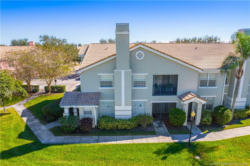 160 Southwest Peacock Boulevard, Unit 31203 Port St. Lucie, FL 34986 - Photo 4 of 43 a front view of a house with garden