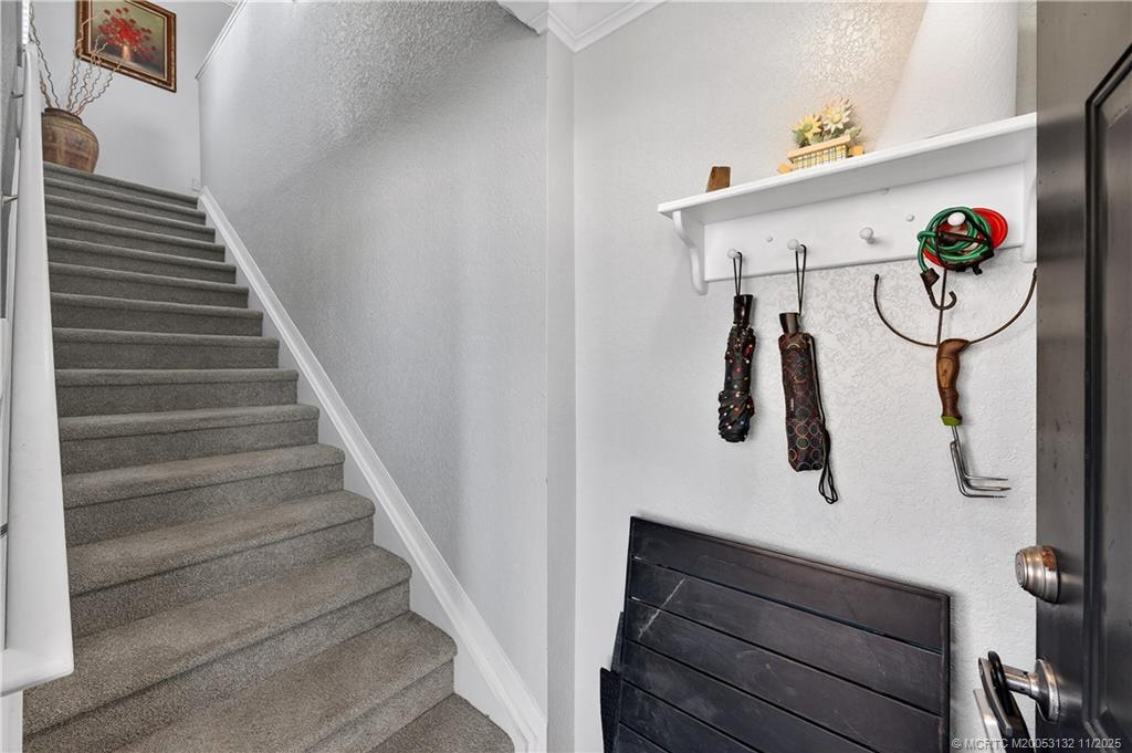160 Southwest Peacock Boulevard, Unit 31203 Port St. Lucie, FL 34986 - Photo 5 of 43 a view of entryway and hall with wooden floor
