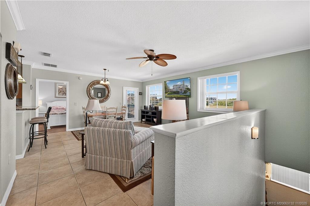 160 Southwest Peacock Boulevard, Unit 31203 Port St. Lucie, FL 34986 - Photo 6 of 43 a living room with furniture and a window