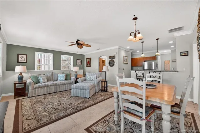 a living room with furniture and kitchen view